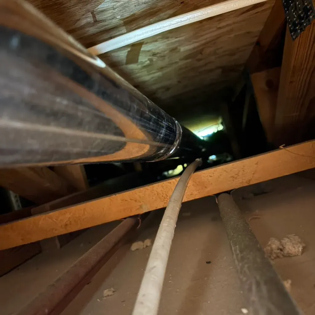 Rods run through ductwork in an attic
