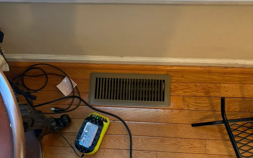 Air duct cleaning under way at a floor register