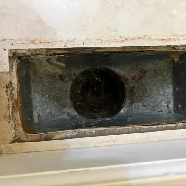 Air duct cleaning in New Windsor, NY: example job photo of a dusty register boot before cleaning
