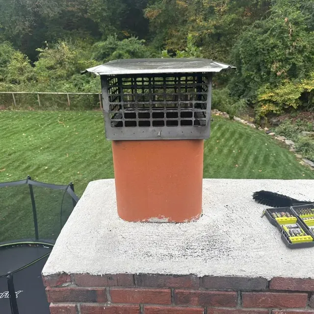 The same clay flue with a stainless cap and spark screen fitted