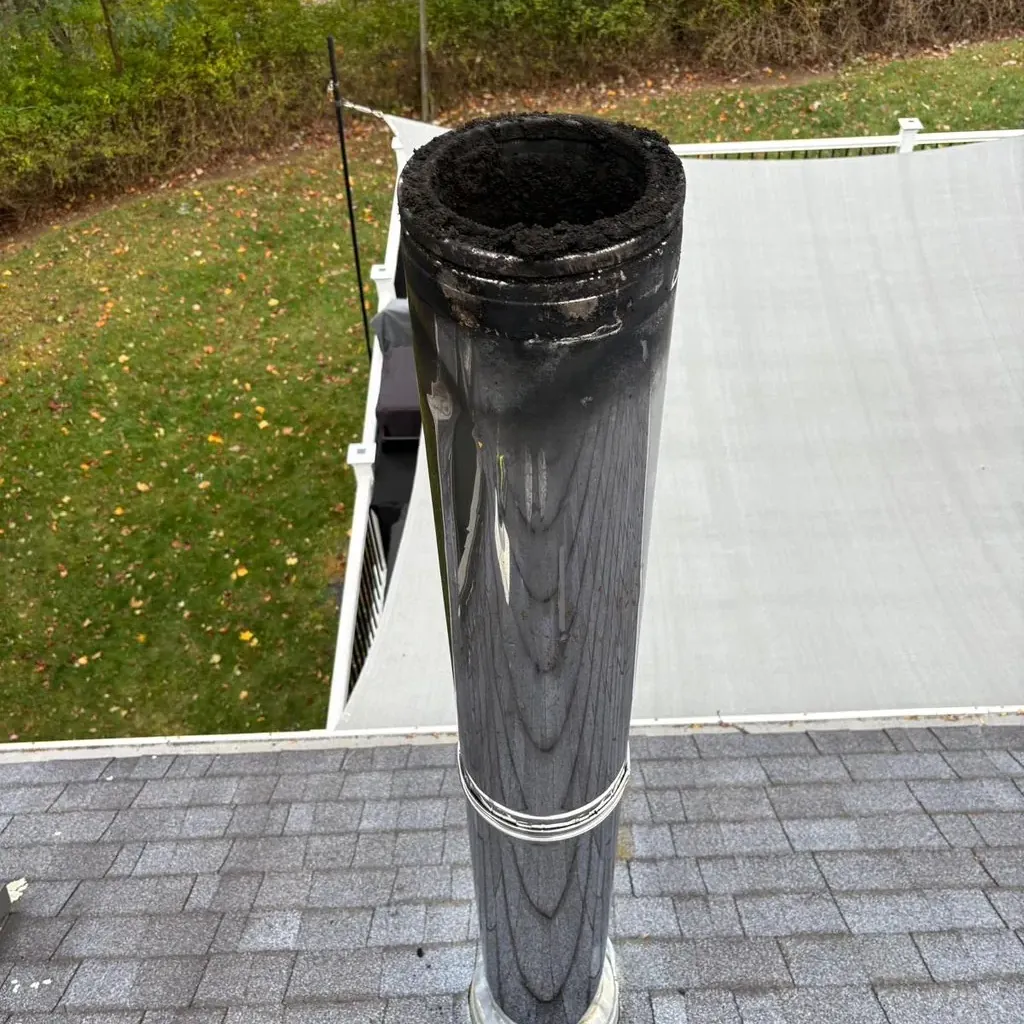 Chimney cap with a spark screen over a metal flue
