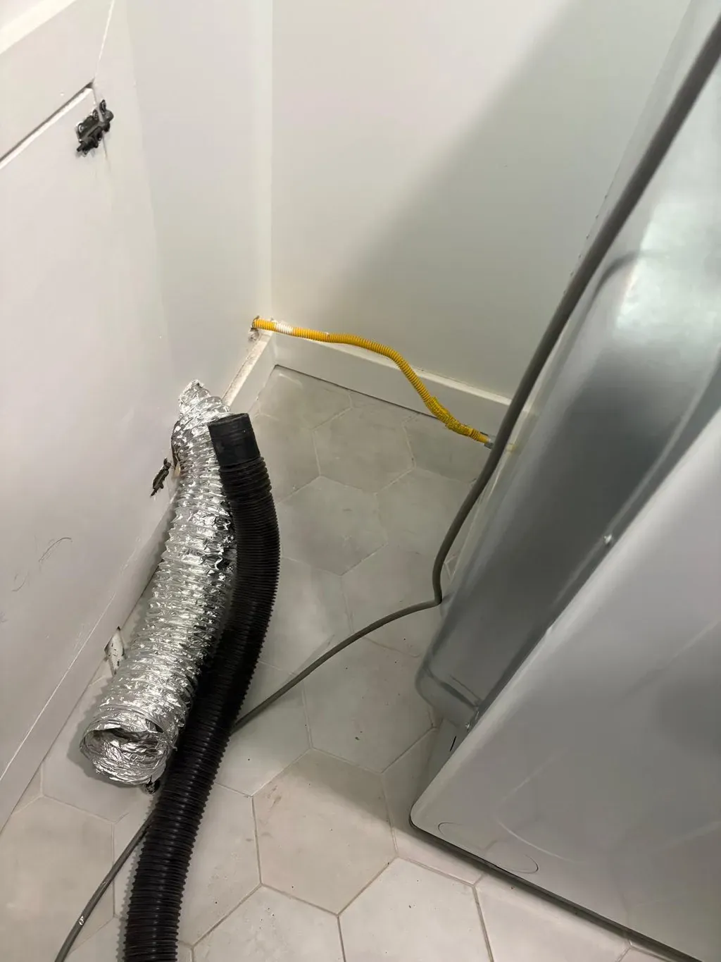 Dryer vent cleaning in Newburgh, NY by Your Neighbor's Air Care: example job photo, dryer pulled out and the hose off