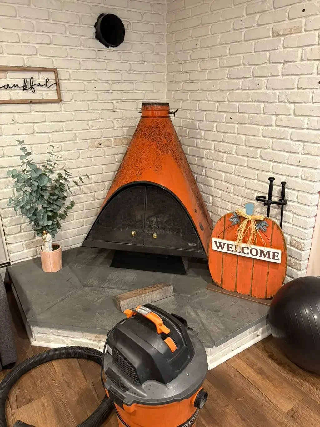 Freestanding fireplace with the vacuum set up for its pre-season clean