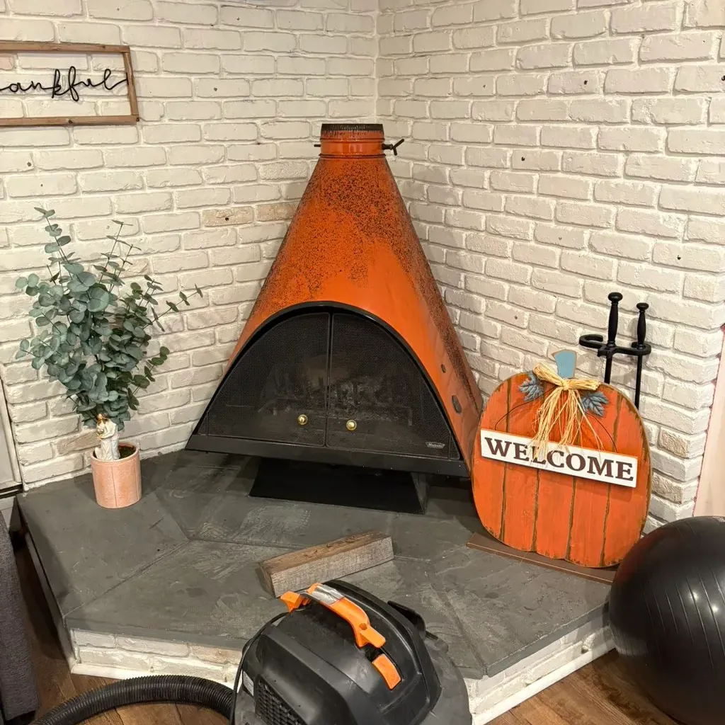 Freestanding fireplace with the vacuum set up for its pre-season clean